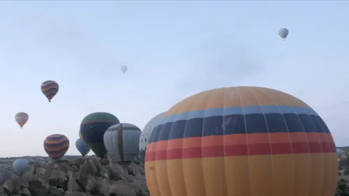Turkey, Cappadocia - Colorful hot air balloons floating across Cappadocia