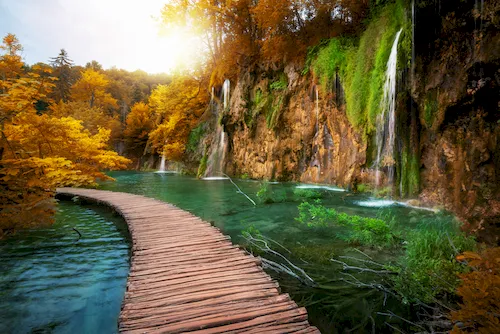 Croatia, Plitvice Lakes National Park - Wooden path for nature trekking with lakes and waterfalls.