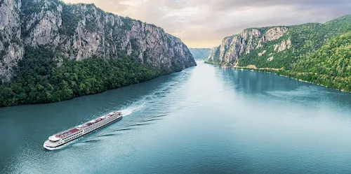 Serbia - Passenger vessel cruising through the picturesque Iron Gate Gorge on a summer trip