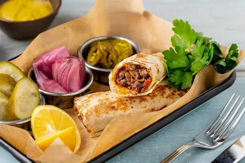 Turkey, Mersin - Turkish kebab tantuni served with sauce and pickles. Mersin tantuni wrap