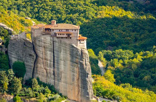Greece, Meteora - Monastery with red roofs on the rocks on a sunny summer day