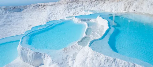 Turkey, Pamukkale - Thermal springs and natural baths with blue water in the travertine pools