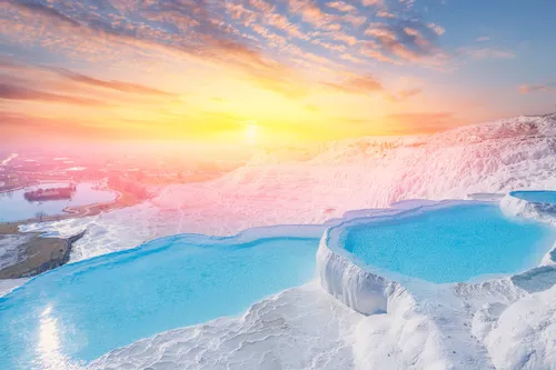 Turkey, Pamukkale - Thermal springs with blue water in the travertine pools at sunset