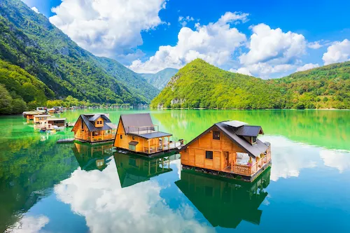 Serbia, Perućac - Floating wooden houses on the turquoise Perucac Lake