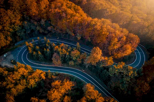 Romania - Transfăgărășan serpentine road through an autumn forest